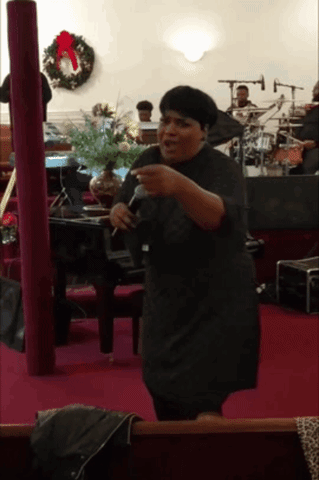 Woman Singing Into Microphone With Wreath
