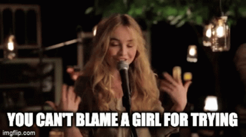 Woman Singing Into Microphone You Can't Blame a Girl for Trying