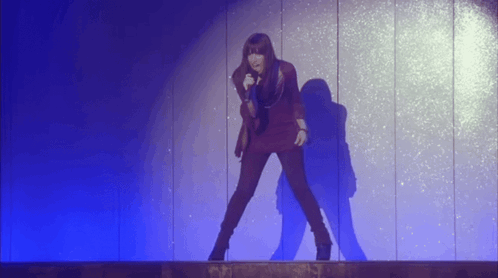 Woman Singing Into Microphone