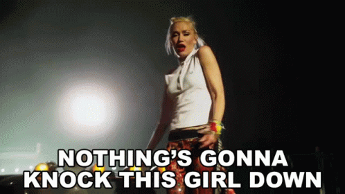 Woman Singing Nothing's Gonna Knock This Girl Down In Dark Room GIF