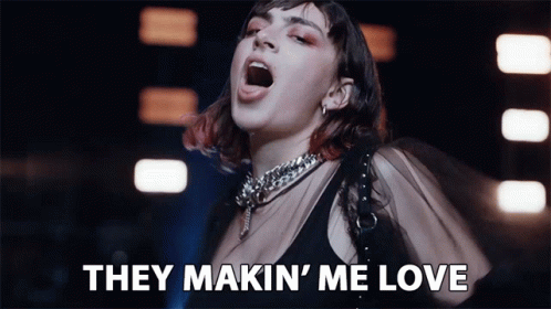 Woman Singing They Makin' Me Love in Dark Room