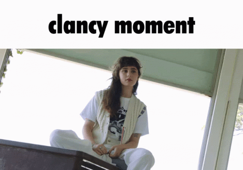 Woman Sits on Box With Clancy Moment