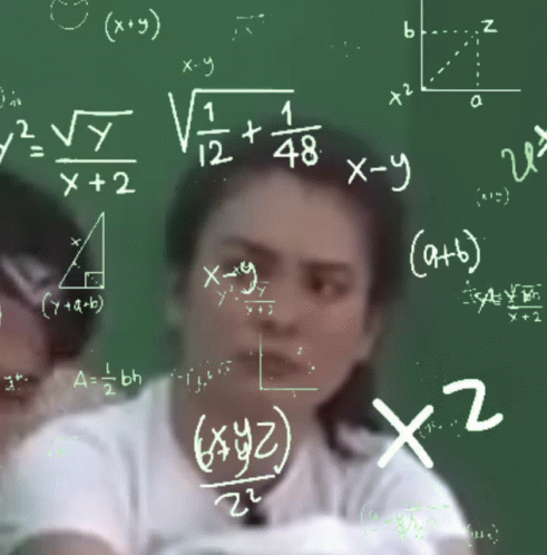 Woman Sitting at Chalkboard With Math Equations