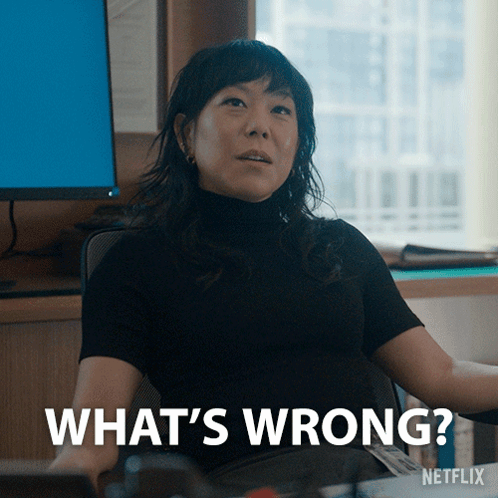 Woman Sitting at Computer Saying What's Wrong