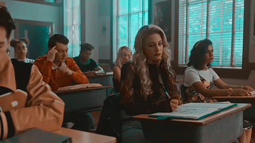 Woman Sitting At Desk In Classroom GIF