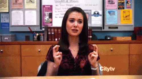 Woman Sitting at Desk in Front of Citytv Sign