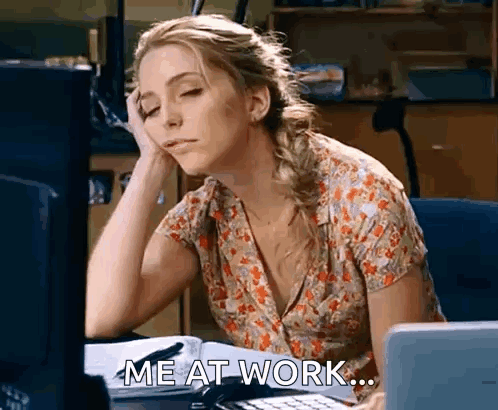 Woman Sitting At Desk With Hand On Forehead GIF