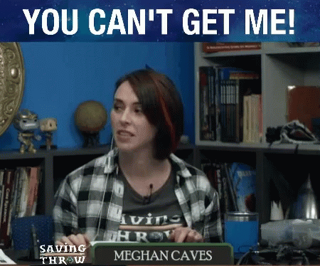 Woman Sitting at Desk With Meghan Caves Sign