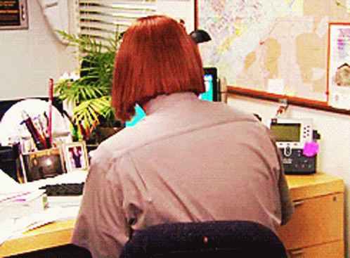 Woman Sitting at Desk with Telephone and Map