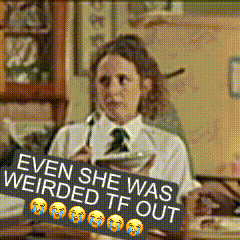 Woman Sitting at Desk With Weirded Out Sign