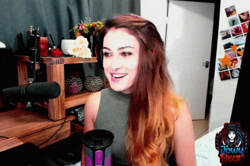 Woman Sitting at Microphone With Jowy Bear