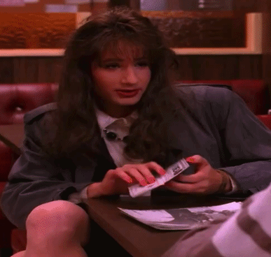 Woman Sitting at Table Holding DEA Passport
