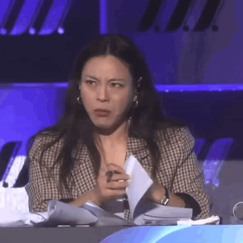 Woman Sitting At Table Holding Paper GIF