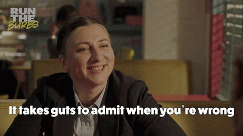 Woman Sitting at Table It Takes Guts to Admit When You're Wrong