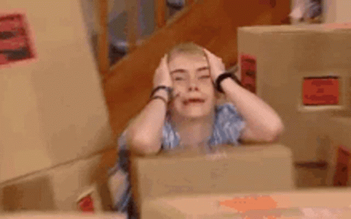 Woman Sitting At Table Making Funny Face GIF