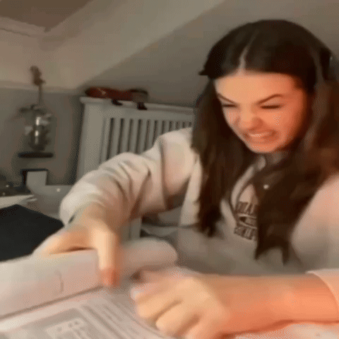 Woman Sitting at Table Reading Book