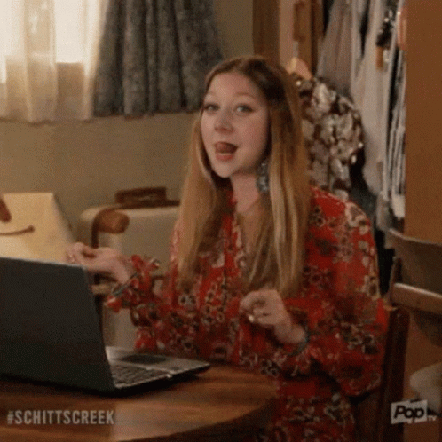 Woman Sitting At Table Using Laptop GIF