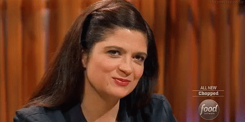 Woman Sitting at Table With All New Chopped Sign