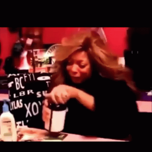 Woman Sitting At Table With BC Sign GIF