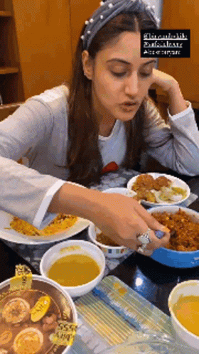 Woman Sitting At Table With Bowls Of Food GIF