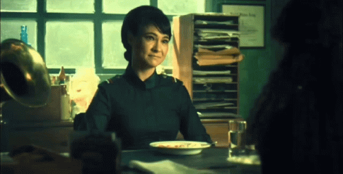 Woman Sitting at Table with Food