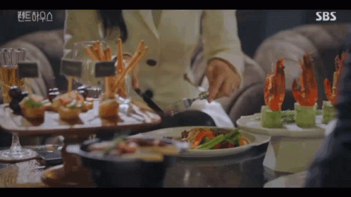 Woman Sitting at Table with Food