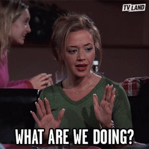 Woman Sitting at Table With Hands Up What Are We Doing