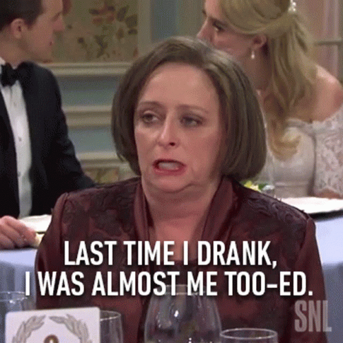 Woman Sitting At Table With Last Time I Drank Sign GIF