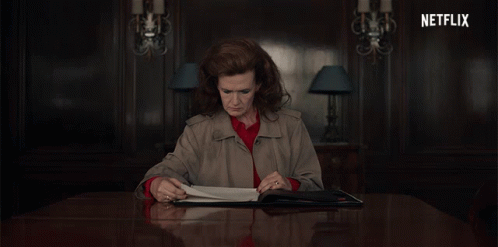 Woman Sitting at Table With Netflix Logo