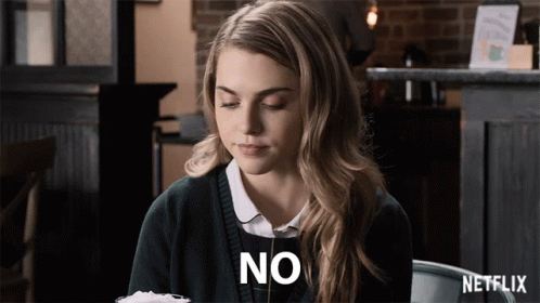 Woman Sitting At Table With Netflix Logo GIF