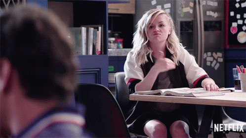 Woman Sitting At Table With Netflix Logo GIF