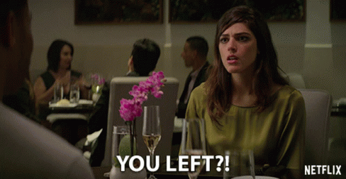 Woman Sitting At Table With Netflix Logo GIF