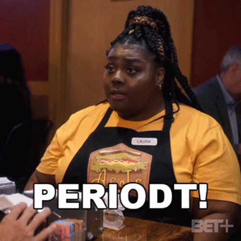 Woman Sitting at Table with Periodt