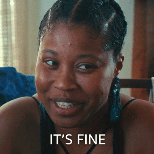 Woman Sitting At Table With Plate, Saying It's Delicious GIF