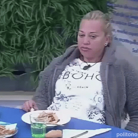 Woman Sitting At Table With Plates Of Food And Water GIF