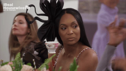 Woman Sitting At Table With Tea Real Housewives GIF