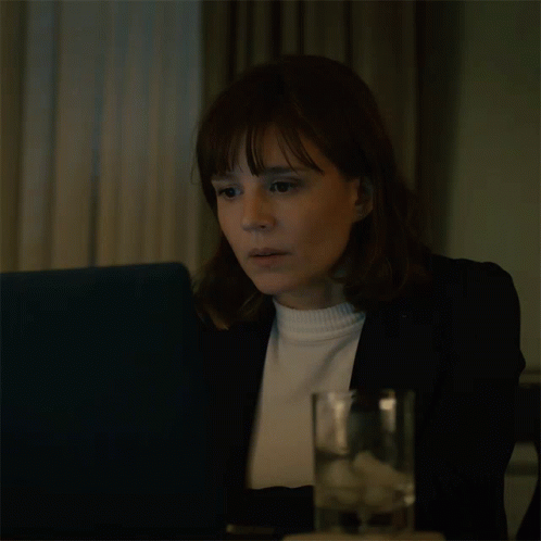 Woman Sitting At Table With Water And Laptop GIF