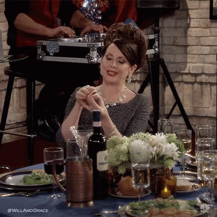 Woman Sitting At Table With Wine GIF