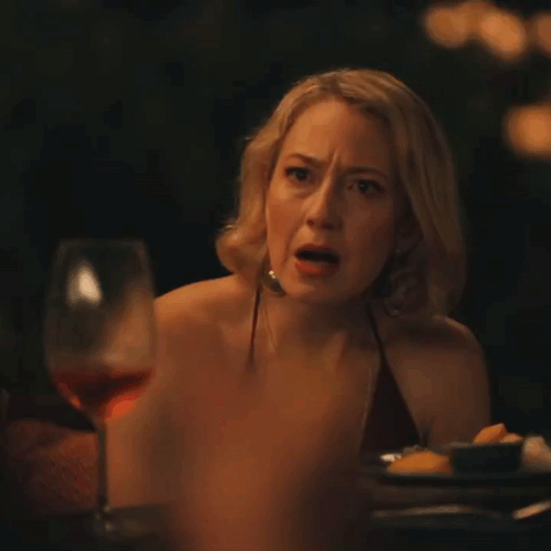 Woman Sitting at Table with Wine