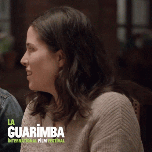 Woman Sitting Before La Guarimba Sign GIF