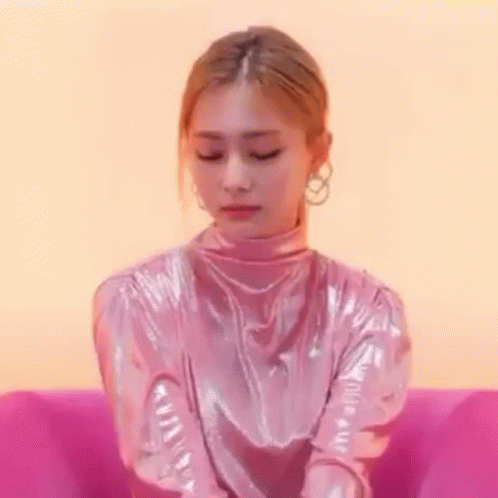 Woman Sitting Crossed Arms in Pink Chair