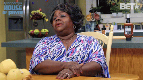 Woman Sitting Eyes Closed at Tyler Perry's House of Payne Sign