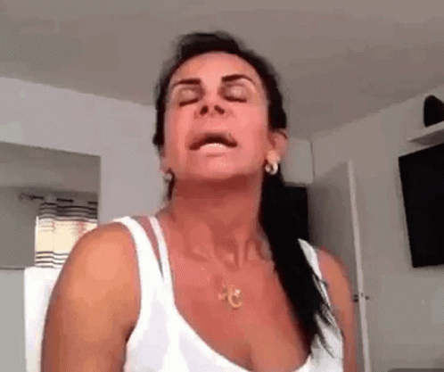 Woman Sitting Eyes Closed in White Tank Top