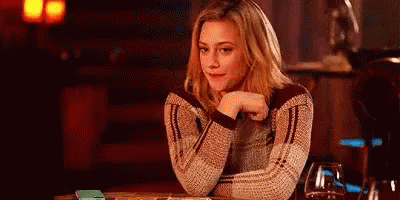 Woman Sitting Hand On Chin Looking At Camera GIF