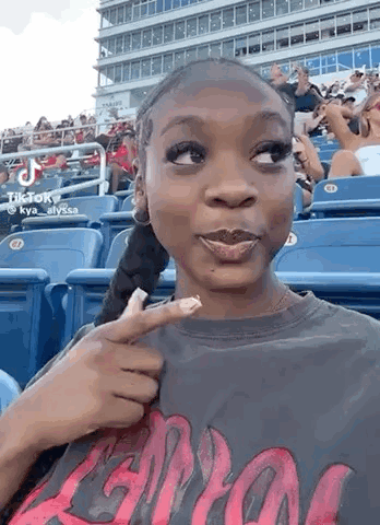 Woman Sitting in Baseball Stadium Stands