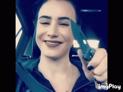Woman Sitting in Car Holding Knife