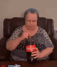 Woman Sitting in Chair Holding Coca Cola