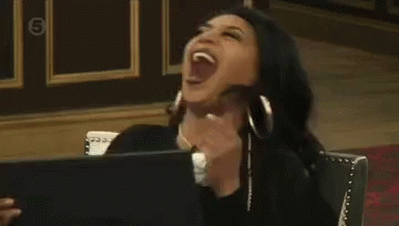 Woman Sitting in Chair Laughing