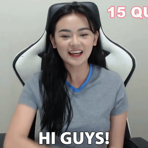 Woman Sitting in Chair Saying Hi Guys