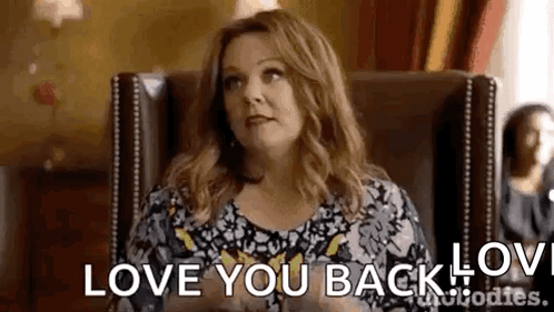 Woman Sitting in Chair Saying Love You Back